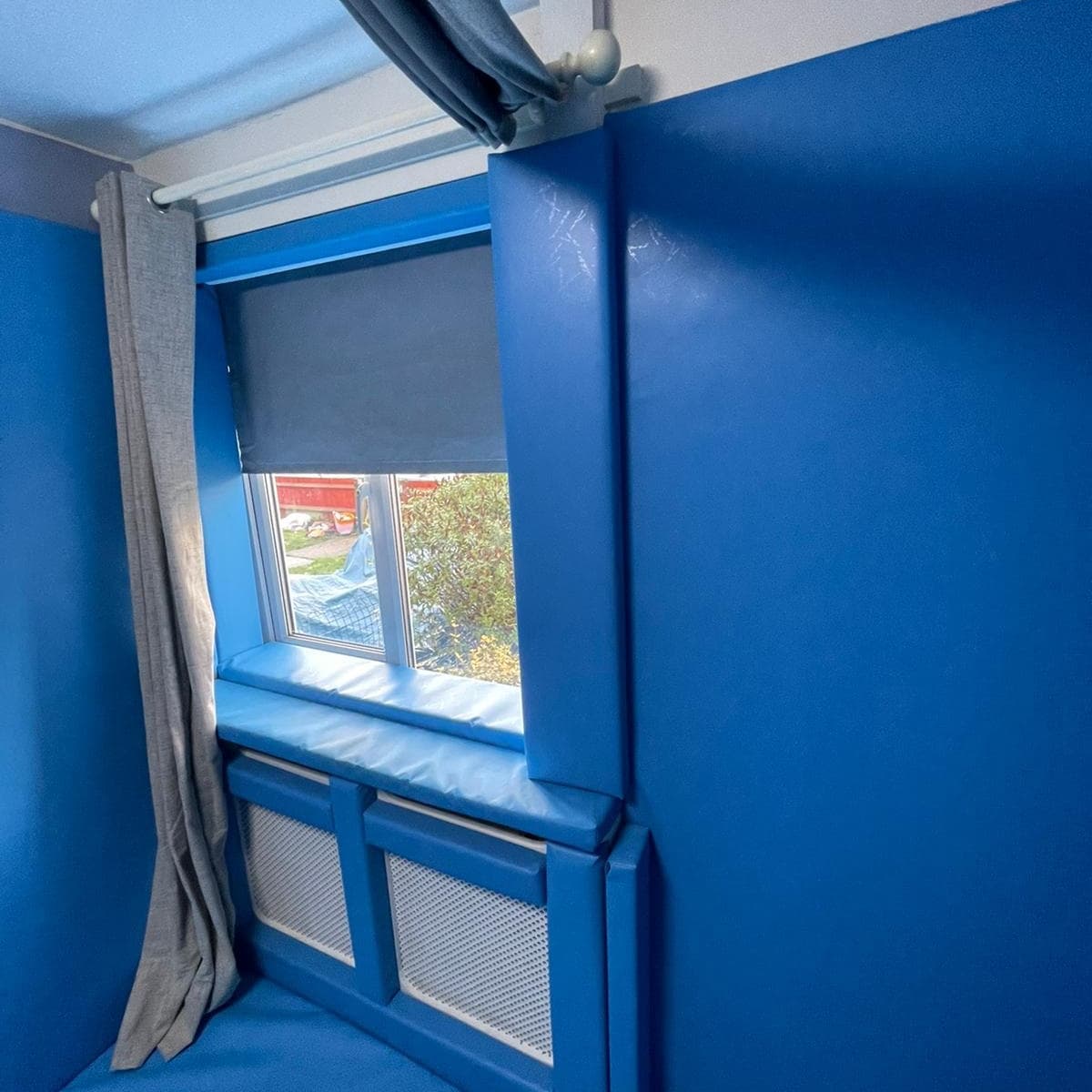 radiator boxing in and padding in safe room with padded walls